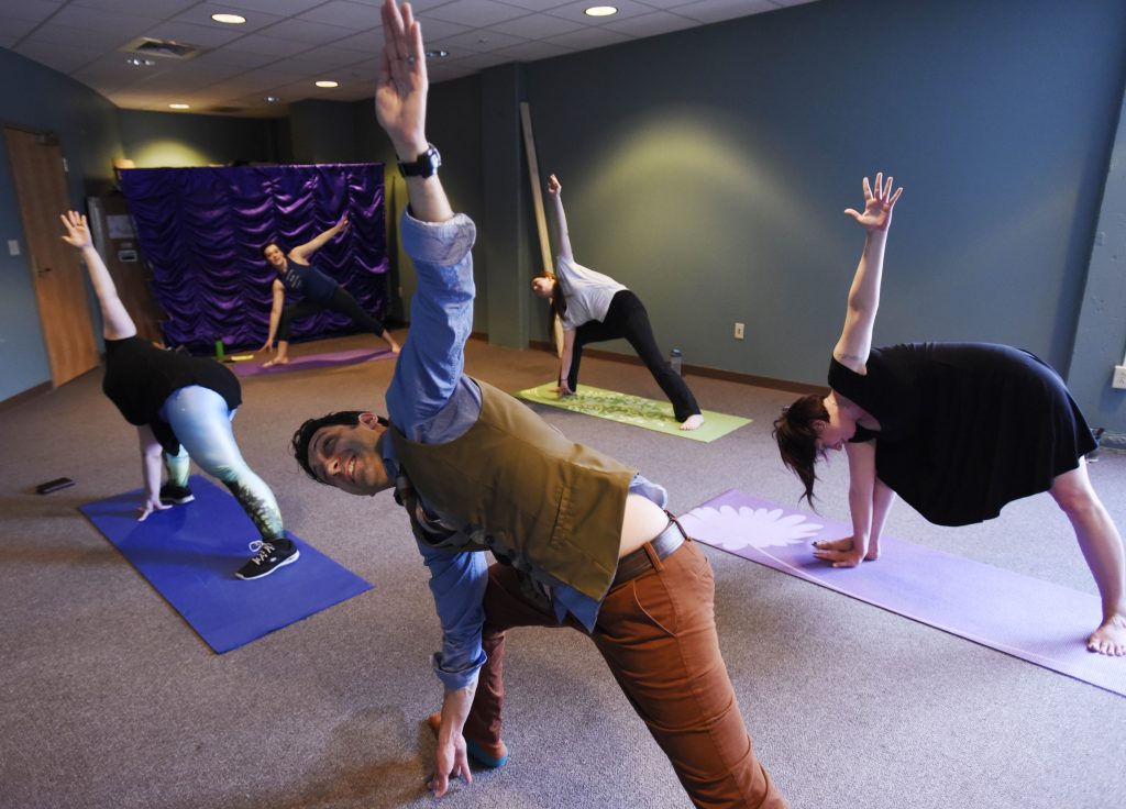 Proctors employees take a 30 minute break to do yoga in the office. The weekly class started a month and a half ago, and managers have been supportive of their staff taking the time to stretch, breathe and reset before returning to work.