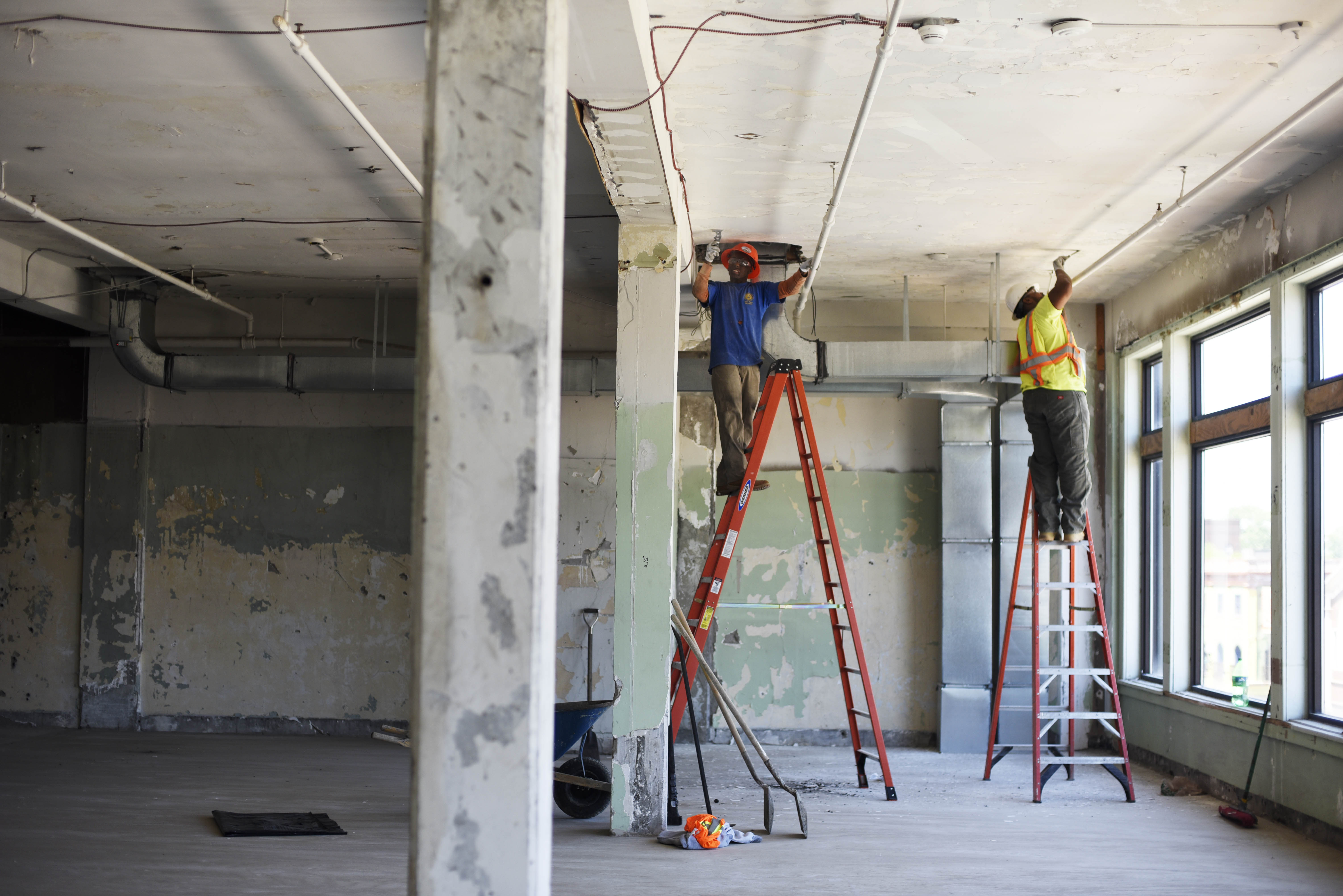 A small crew scrapes paint off the ceiling during the first day of construction on The Adeline Graham Theatrical Training and Innovation Center at Proctors, nicknamed The Addy, Wednesday, June 7, 2017.