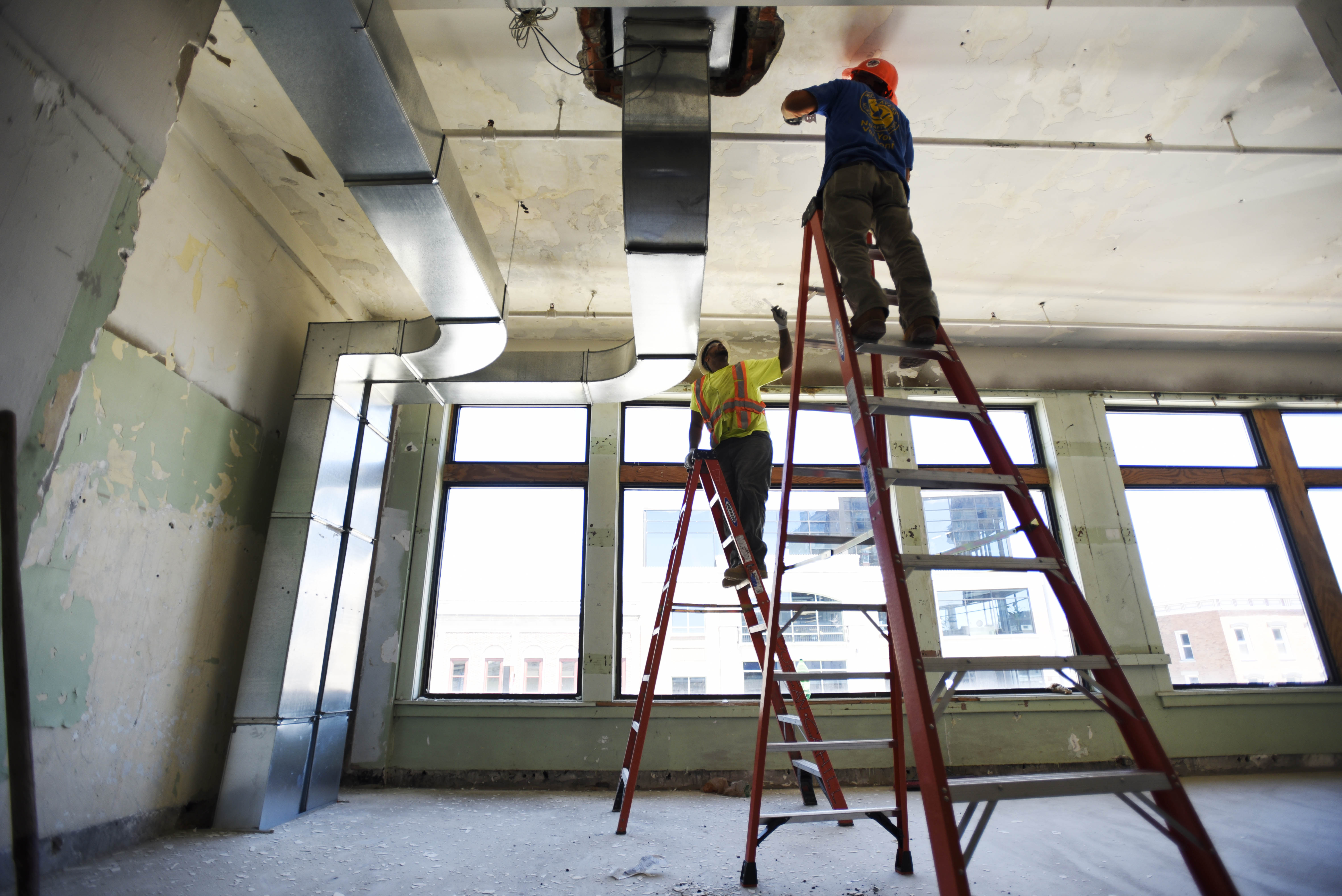 A small crew scrapes paint off the ceiling during the first day of construction on The Adeline Graham Theatrical Training and Innovation Center at Proctors, nicknamed The Addy, Wednesday, June 7, 2017.