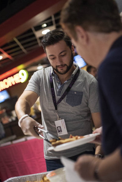 Graphic designer Vincent Gabriele serves chicken wings as Proctors celebrates their volunteers at their annual Volunteer Appreciation Night Monday, October 29, 2018.